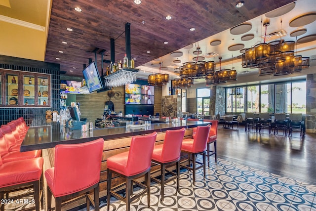 bar with a towering ceiling and wood ceiling