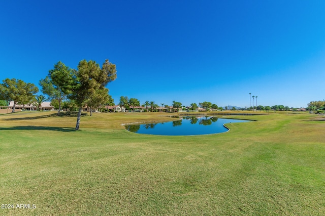 view of community featuring a water view and a lawn