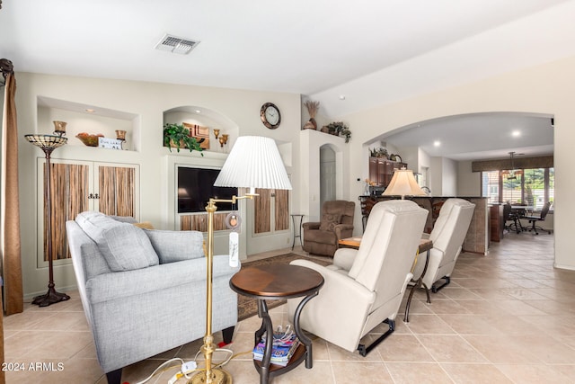 tiled living room featuring lofted ceiling