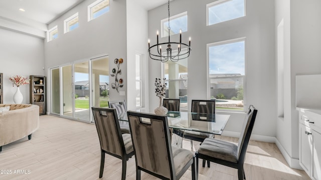 25228 S Star Dr, Queen Creek, AZ 85142 - dining area with a chandelier, a high ceiling, and plenty of natural light