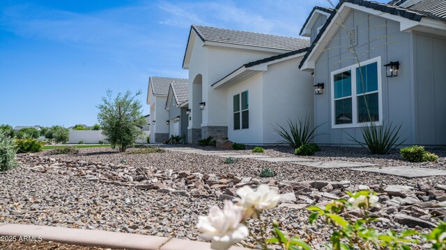 25228 S Star Dr, Queen Creek, AZ 85142 - view of side of property with a tile roof, stucco siding, and brick siding