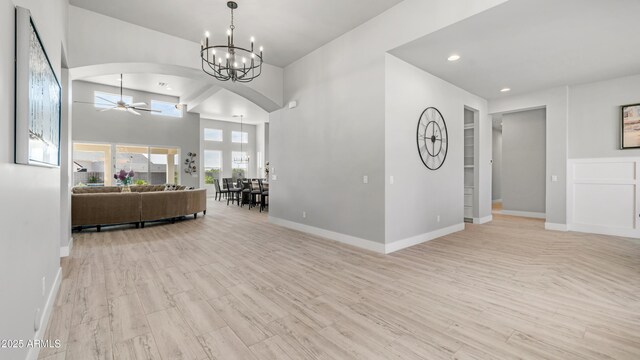 25228 S Star Dr, Queen Creek, AZ 85142 - interior space featuring arched walkways, light wood-style floors, baseboards, and ceiling fan with notable chandelier