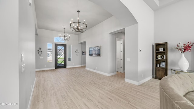 25228 S Star Dr, Queen Creek, AZ 85142 - foyer featuring light wood finished floors, a chandelier, baseboards, and a high ceiling