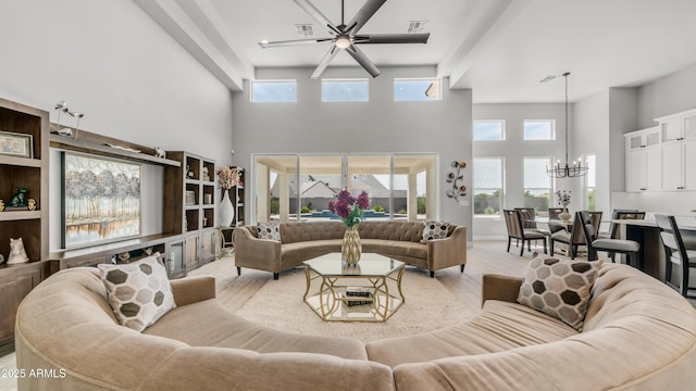 25228 S Star Dr, Queen Creek, AZ 85142 - living room featuring light wood finished floors, visible vents, a towering ceiling, and ceiling fan with notable chandelier