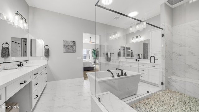 25228 S Star Dr, Queen Creek, AZ 85142 - ensuite bathroom with two vanities, marble finish floor, a freestanding bath, and a sink