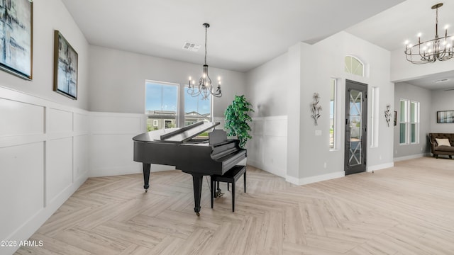 25228 S Star Dr, Queen Creek, AZ 85142 - living area with a wainscoted wall, a decorative wall, and a notable chandelier