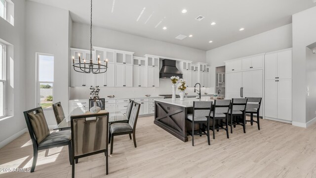 25228 S Star Dr, Queen Creek, AZ 85142 - kitchen featuring a sink, a kitchen breakfast bar, a towering ceiling, a notable chandelier, and custom range hood