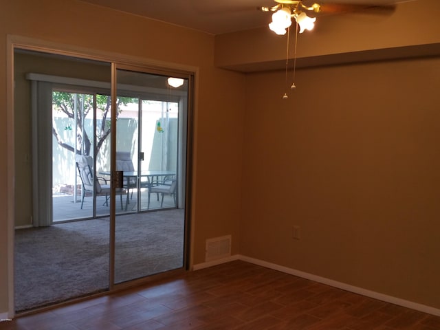 spare room featuring wood-type flooring and ceiling fan