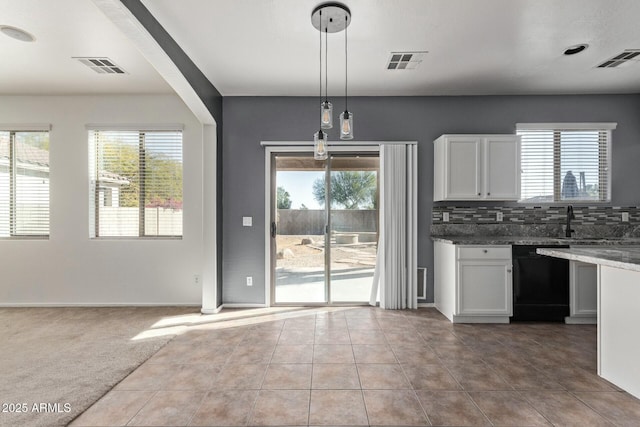 kitchen with decorative backsplash, carpet, decorative light fixtures, dishwasher, and white cabinetry