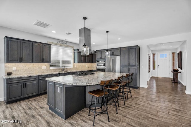 175 E Santa Lucia Ln, Queen Creek, AZ 85140 - kitchen with visible vents, a large island, island exhaust hood, a sink, and stainless steel appliances