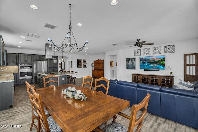 175 E Santa Lucia Ln, Queen Creek, AZ 85140 - dining room featuring visible vents, light wood finished floors, recessed lighting, and ceiling fan with notable chandelier