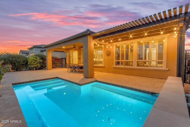 175 E Santa Lucia Ln, Queen Creek, AZ 85140 - pool at dusk with a patio area, an outdoor pool, and a ceiling fan