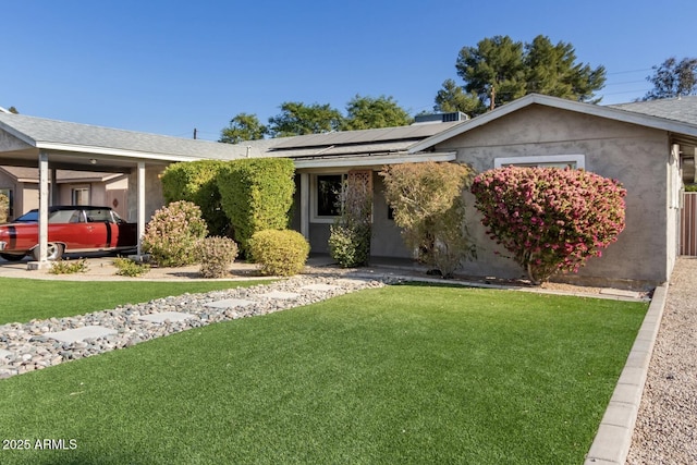 single story home featuring a front yard and solar panels