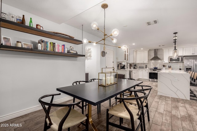 dining area featuring sink and light hardwood / wood-style floors