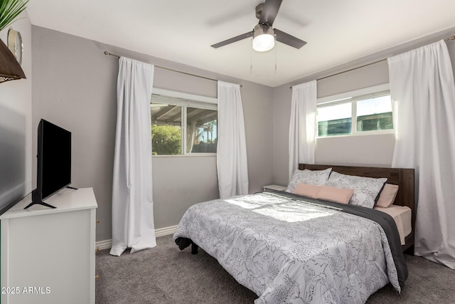 carpeted bedroom with multiple windows and ceiling fan