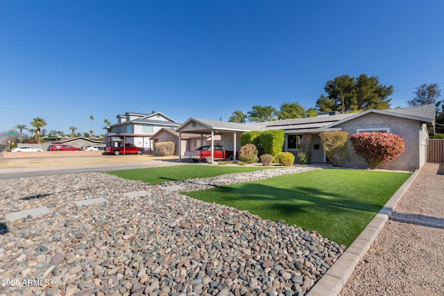 ranch-style home with a front yard and a carport