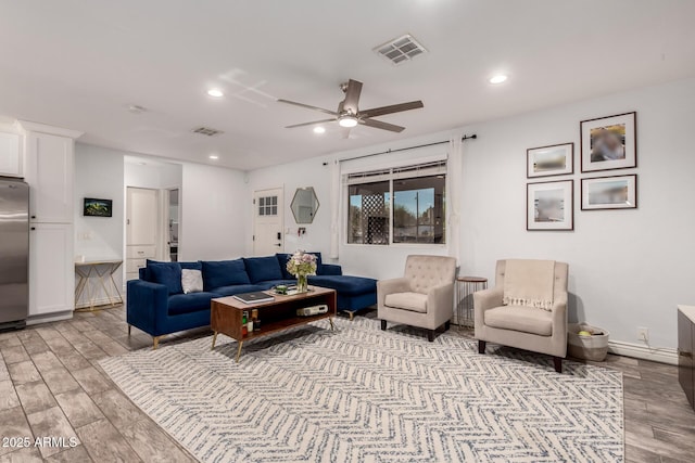 living room featuring ceiling fan and light wood-type flooring