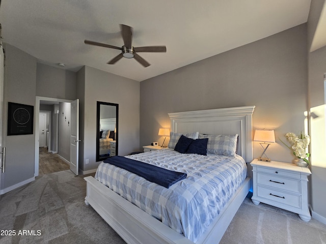 bedroom with baseboards, a ceiling fan, and carpet flooring