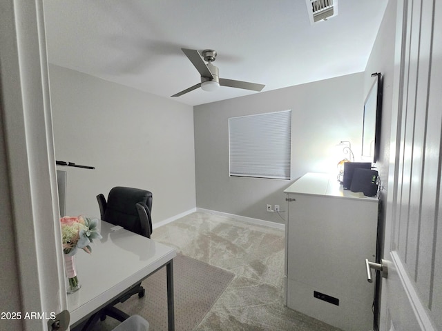 office space featuring ceiling fan, baseboards, visible vents, and light carpet