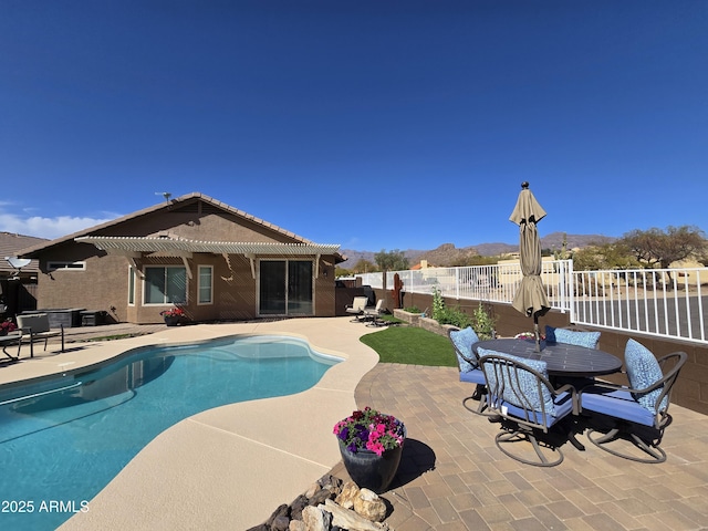 view of swimming pool featuring a patio, a fenced in pool, fence, outdoor dining area, and a pergola