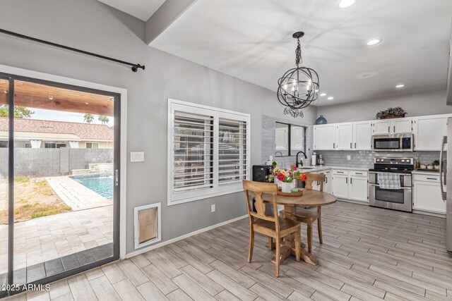 1231 W Mediterranean Dr, Gilbert, AZ 85233 - dining space featuring a chandelier, light wood-style floors, recessed lighting, and baseboards