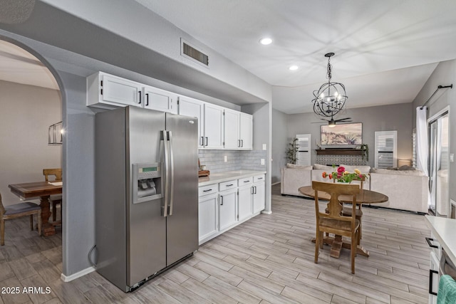 1231 W Mediterranean Dr, Gilbert, AZ 85233 - kitchen featuring stainless steel fridge, light countertops, white cabinetry, light wood-type flooring, and recessed lighting