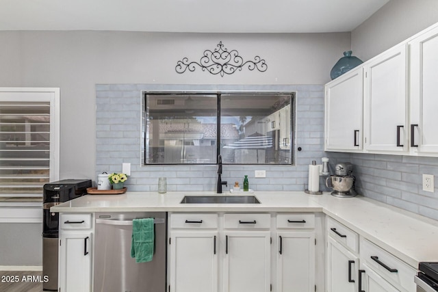 1231 W Mediterranean Dr, Gilbert, AZ 85233 - kitchen with dishwasher, a sink, white cabinetry, and tasteful backsplash