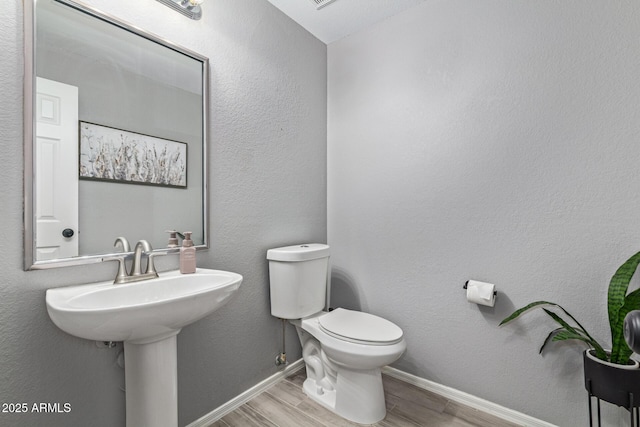 1231 W Mediterranean Dr, Gilbert, AZ 85233 - bathroom with wood finished floors, toilet, and baseboards