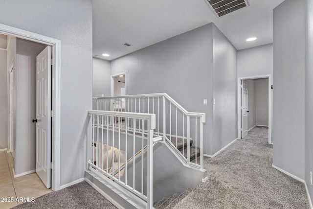 1231 W Mediterranean Dr, Gilbert, AZ 85233 - hallway with an upstairs landing, carpet flooring, baseboards, and tile patterned flooring