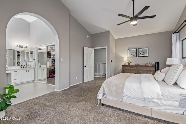 1231 W Mediterranean Dr, Gilbert, AZ 85233 - bedroom with arched walkways, carpet, baseboards, ensuite bath, and high vaulted ceiling