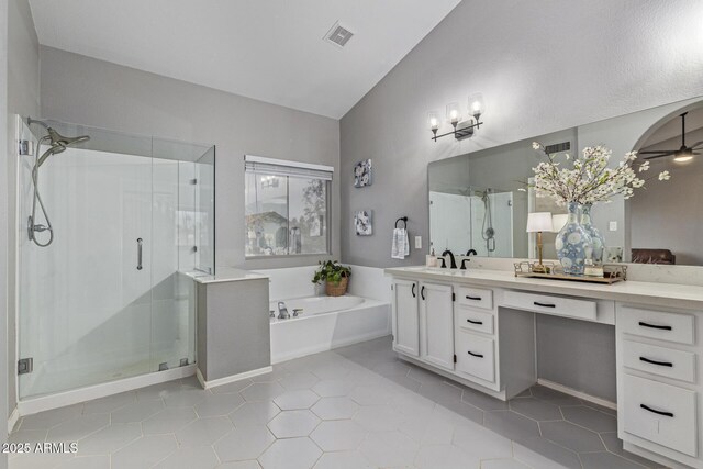 1231 W Mediterranean Dr, Gilbert, AZ 85233 - full bath with a garden tub, a shower stall, double vanity, vaulted ceiling, and tile patterned floors