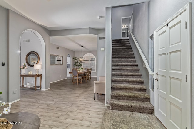 1231 W Mediterranean Dr, Gilbert, AZ 85233 - staircase with wood finished floors, arched walkways, and baseboards