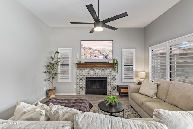 1231 W Mediterranean Dr, Gilbert, AZ 85233 - living room with a tile fireplace, a ceiling fan, wood finished floors, and baseboards