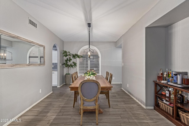 1231 W Mediterranean Dr, Gilbert, AZ 85233 - dining space with arched walkways, wood finished floors, baseboards, and a chandelier
