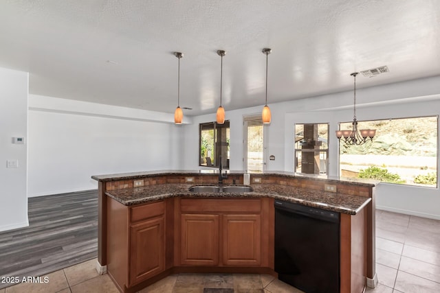 kitchen featuring a sink, visible vents, dark stone counters, and dishwasher