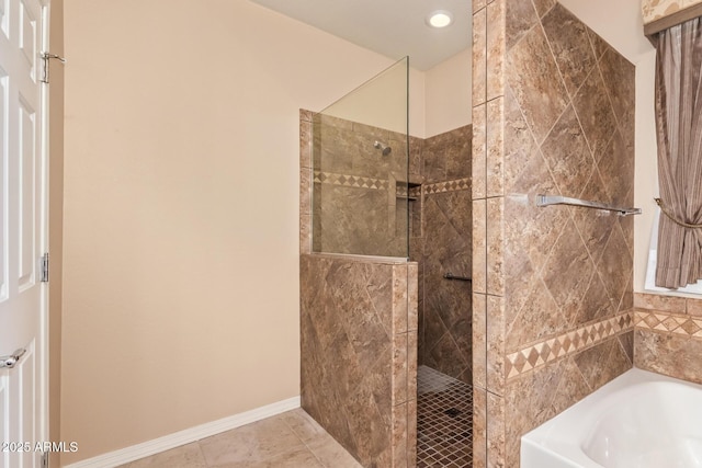full bath featuring tile patterned floors, a walk in shower, baseboards, and a garden tub