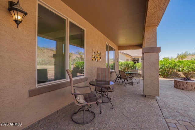 view of patio / terrace with an outdoor fire pit and outdoor dining space