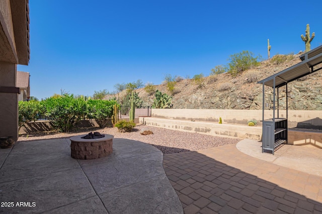 view of patio / terrace with a fire pit and fence