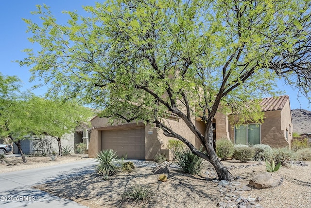 8438 W Bajada Rd, Peoria, AZ 85383 - view of front of property featuring stucco siding, a garage, driveway, and a tile roof