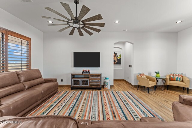 living room with ceiling fan and light hardwood / wood-style floors