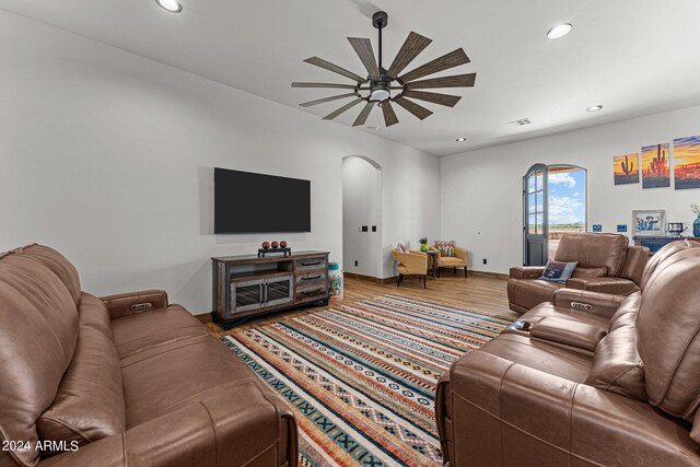 living room with wood-type flooring and ceiling fan