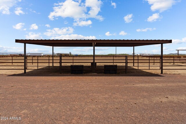 view of stable with a rural view