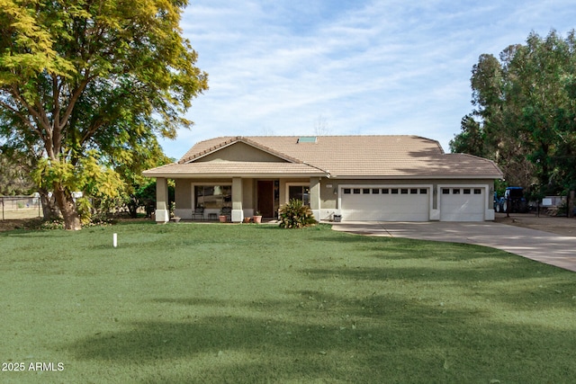 view of front of property featuring a garage, a front lawn, and covered porch