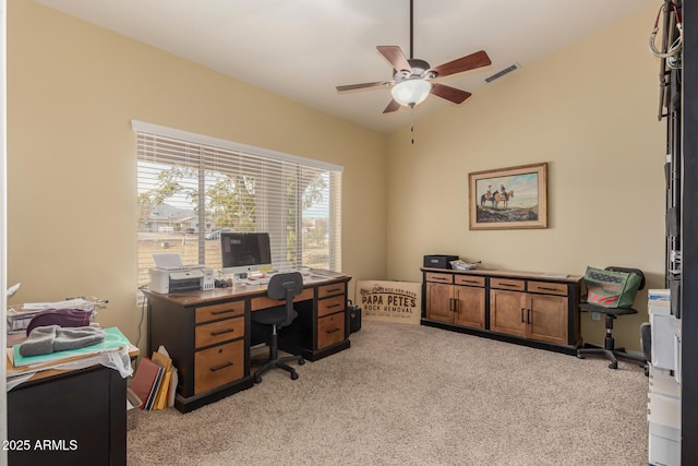 carpeted office space with vaulted ceiling and ceiling fan