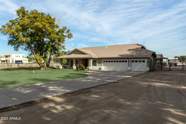 view of front of property with a garage and a front lawn