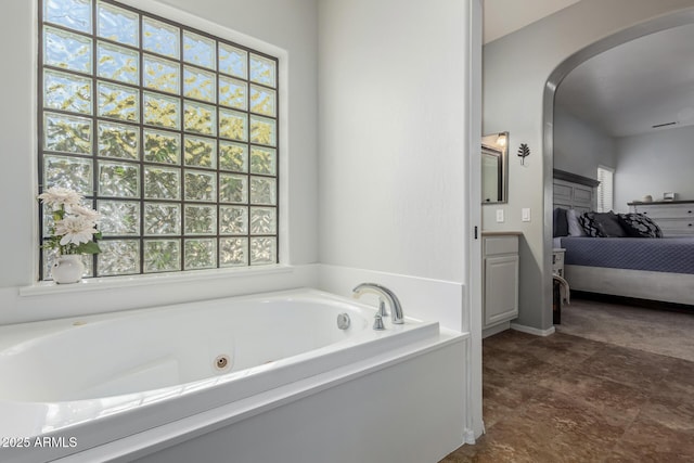 bathroom featuring a bath and a wealth of natural light