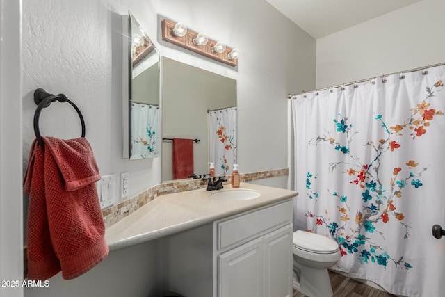 bathroom featuring hardwood / wood-style flooring, vanity, and toilet