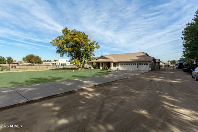 ranch-style home featuring a garage and a front lawn