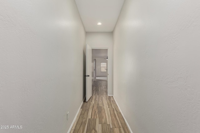 hallway with light hardwood / wood-style flooring