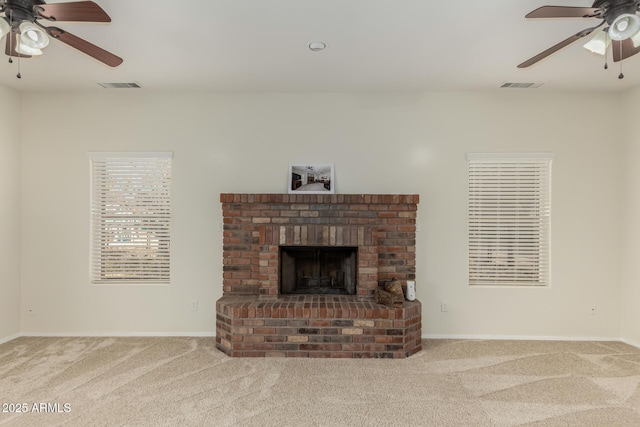 living room featuring ceiling fan, a brick fireplace, and carpet